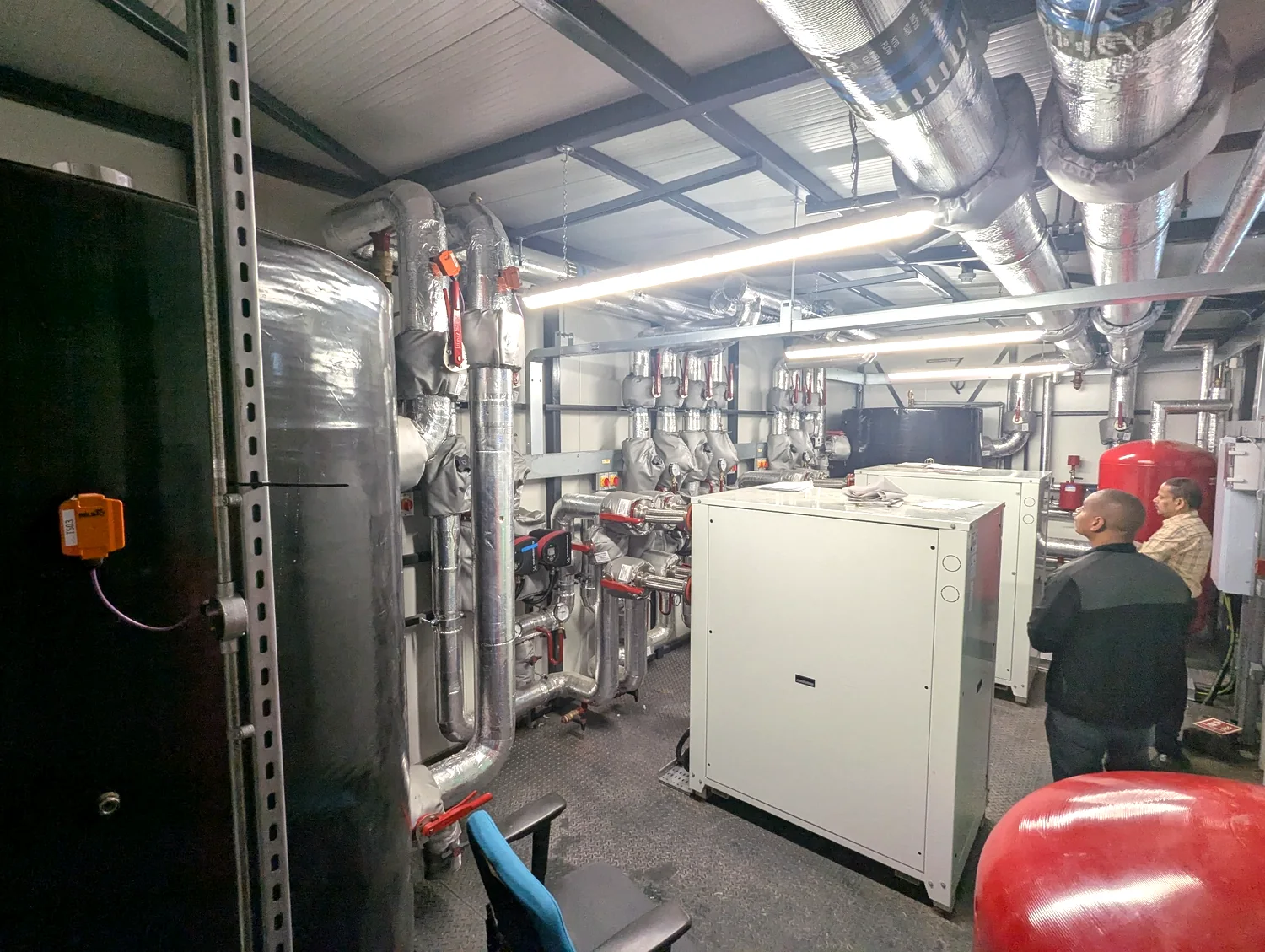 Insulated pipes, tanks and mechanical equipment in an operational plant room